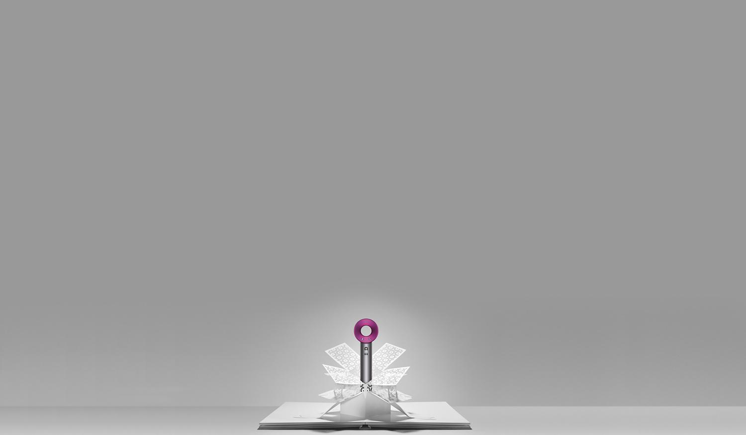 Dyson Supersonic™ styler emerging from paper art